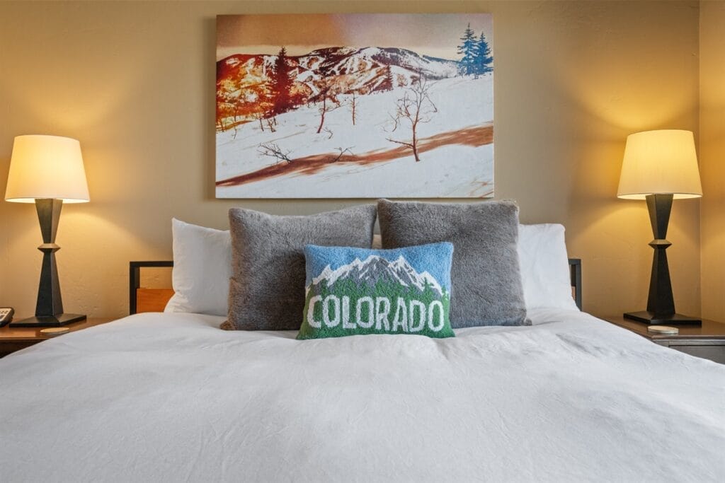 Bed with a Colorado pillow in one of our vacation rentals we manage